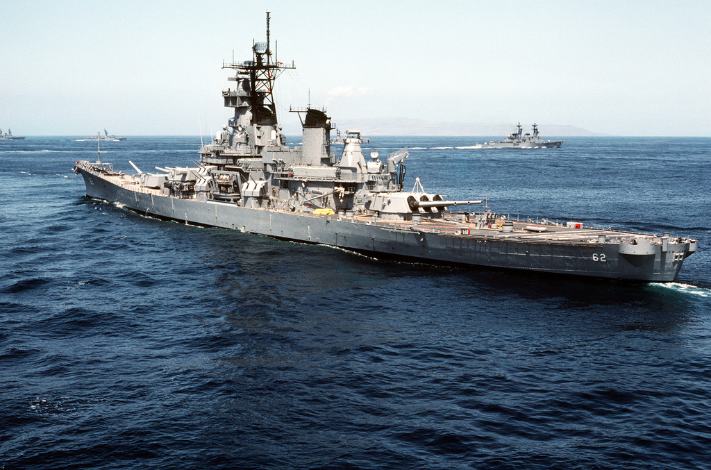 Aerial port quarter view of the battleship USS NEW JERSEY (BB-62). The ...