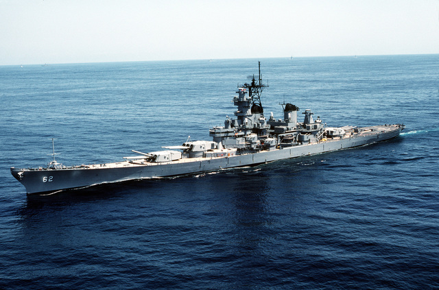 An aerial port view of the battleship USS NEW JERSEY (BB-62) underway ...