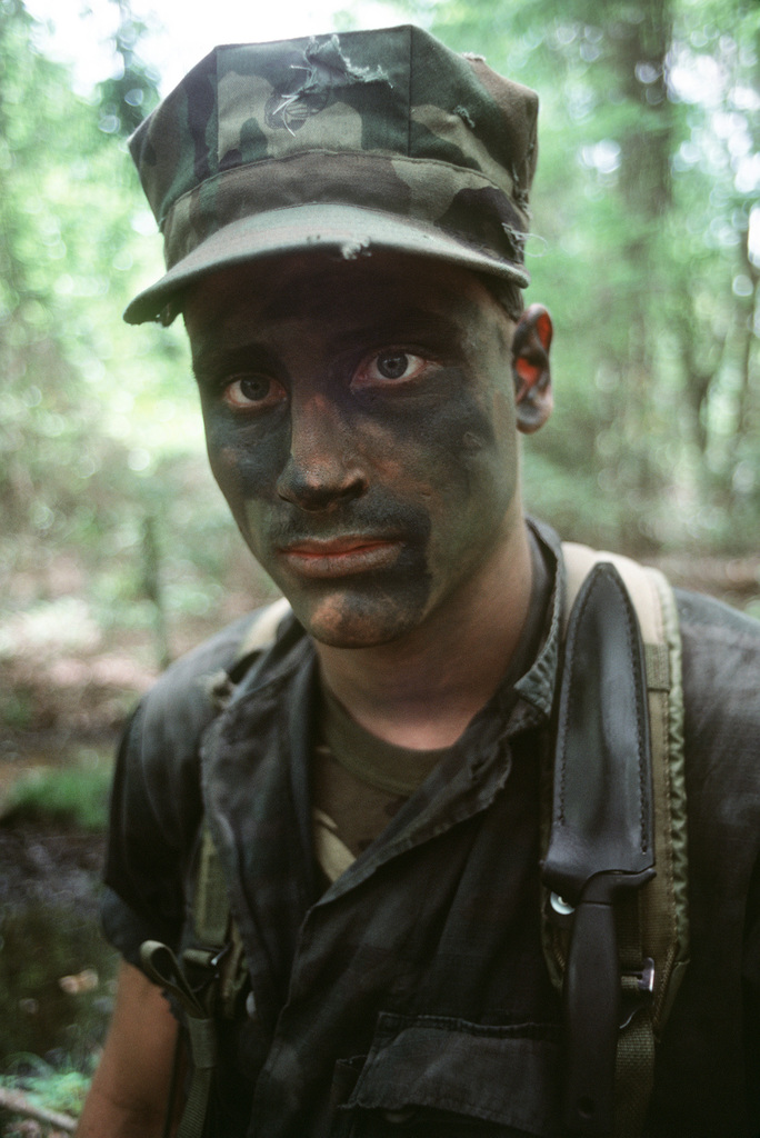 A Marine wearing camouflage face paint participates in Exercise