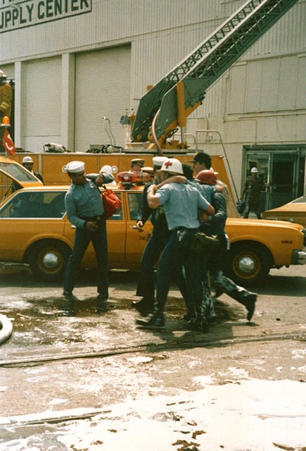 An Injured Firefighter Is Assisted By Medical Personnel After Helping ...