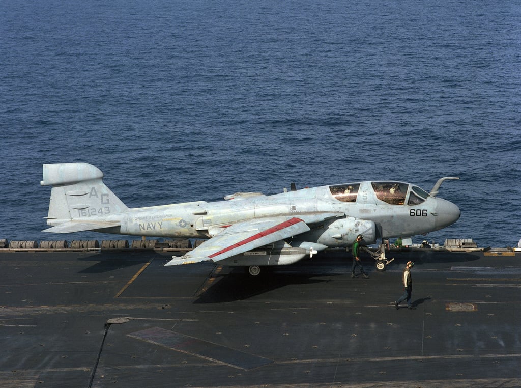 A Catapult Crewman And Plane Director Stand By As An Ea B Prowler Aircraft Is Positioned On A