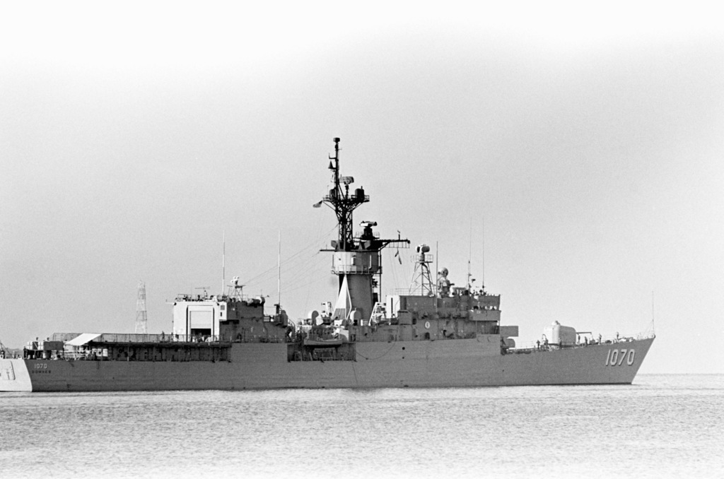 A starboard quarter view of the frigate USS DOWNES (FF 1070) leaving US ...