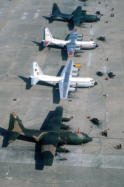 An aerial view of four C-130 Hercules aircraft from Allied countries ...