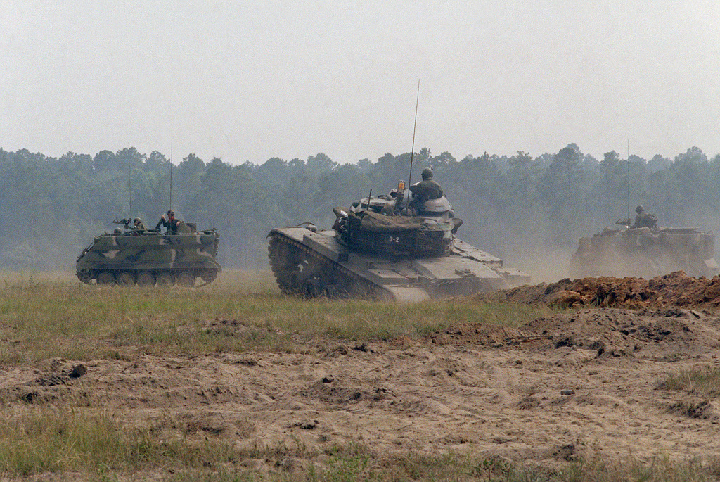 An M60A3 main battle tank (center) and two M113A1 armored personnel ...