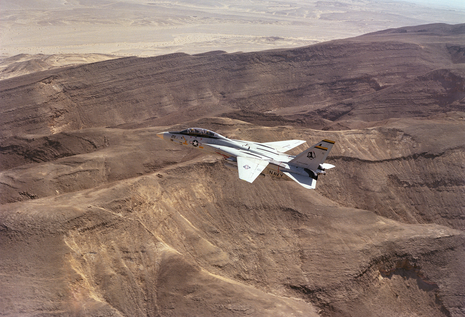 An air-to-air left side view of a F-14 Tomcat aircraft assigned to ...