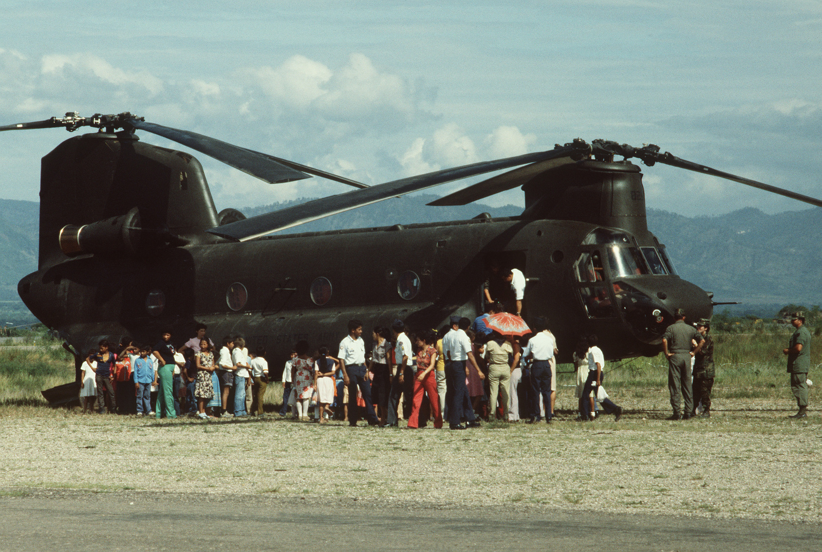 A left side view of a CH-47 Chinook helicopter as a group of Honduran ...