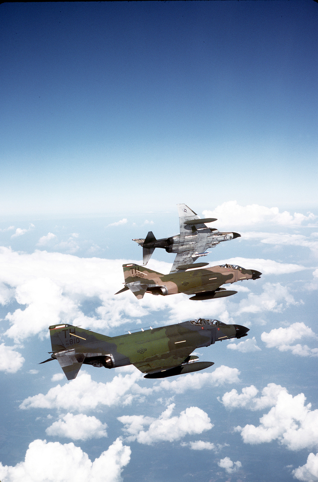 An air-to-air right side view of three F-4 Phantom II aircraft from the ...