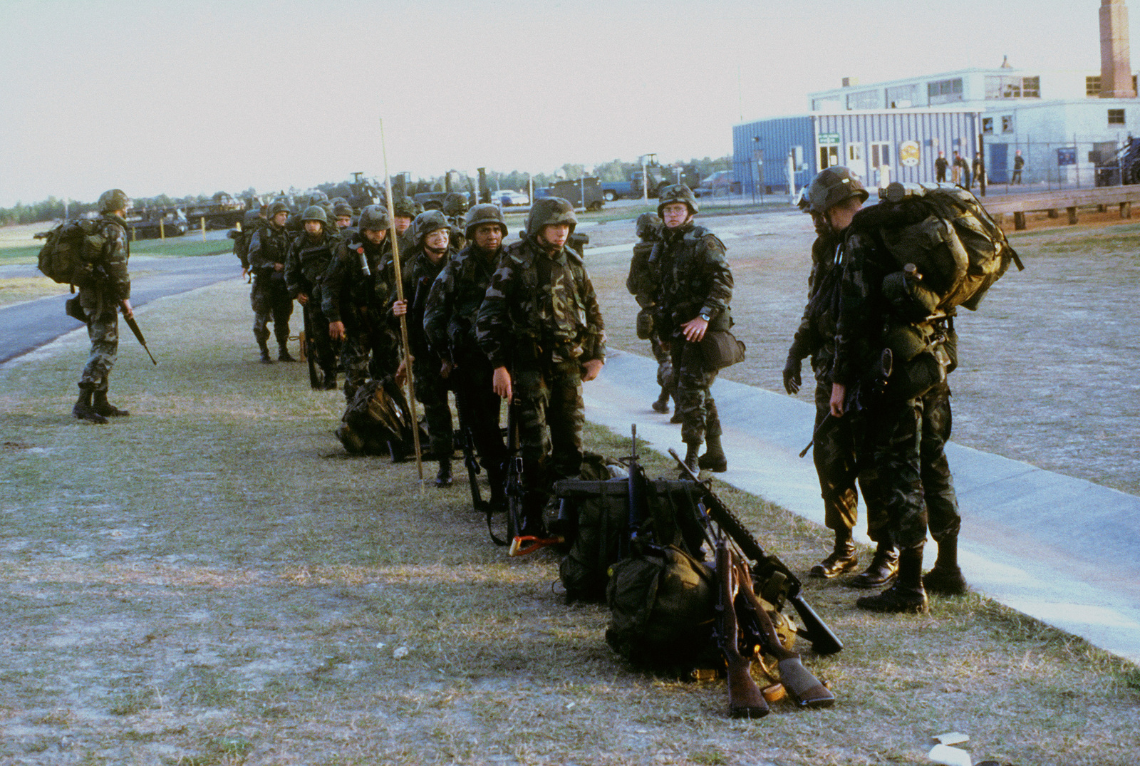 Combat-equipped Members Of The 82nd Airborne Division Wait To Board ...