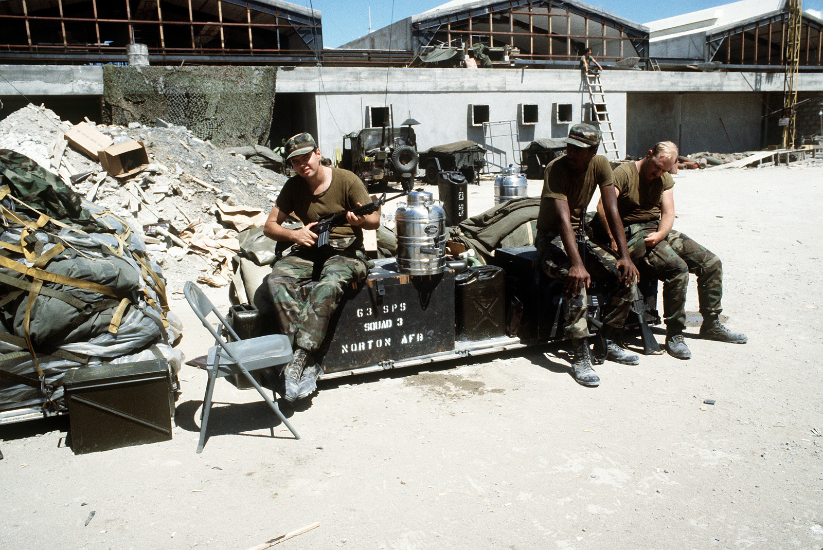 Members Of The 63rd Security Police Squadron Sit Outside The Partially Built Terminal At Point Salines Airport During Operation Urgent Fury One Man Is Armed With An M 16a1 Rifle U S National