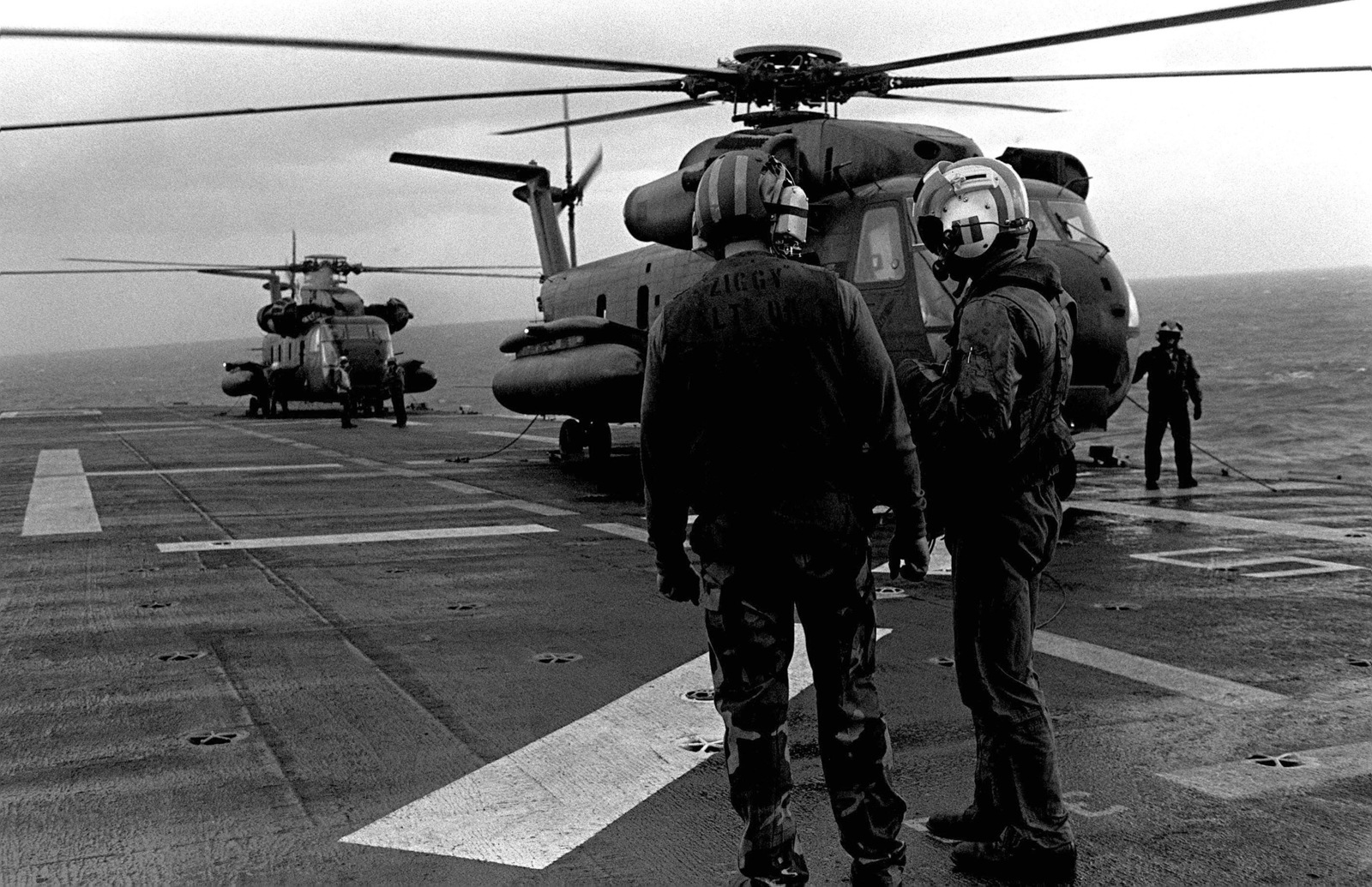 two-crewmen-discuss-their-duties-on-the-flight-deck-of-the-amphibious