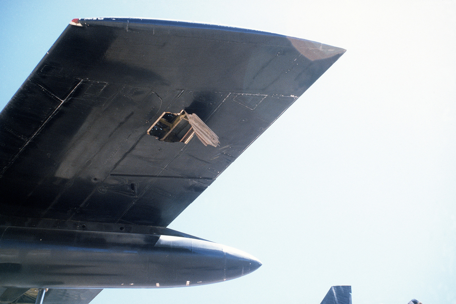 The left wing tip a B-52 Stratofortress aircraft shows damage caused by a high explosive shell ...