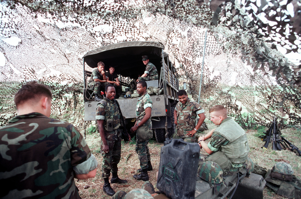 US Marines rest under camouflage netting during Exercise OCEAN VENTURE '84.  Several Marines are in a cargo truck - PICRYL - Public Domain Media Search  Engine Public Domain Search