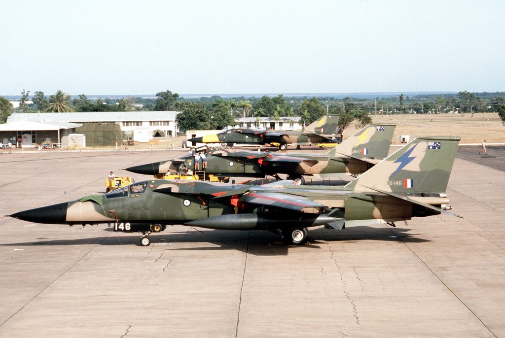 A Left Side View Of Three RAAF F-111 Fighter Aircraft Parked On The ...