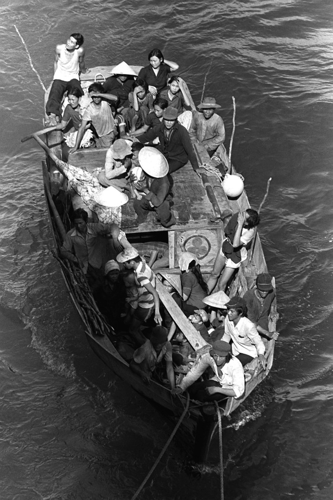 A boat carrying 35 Vietnamese refugees comes along side the amphibious ...