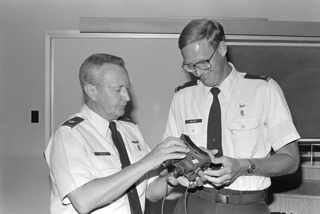 Colonel Thomas J. Tredici (left) explains the mechanics of the AN/PVS ...