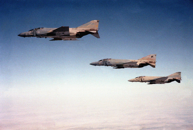 An air-to-air left side view of two F-4S Phantom II aircraft. They are ...