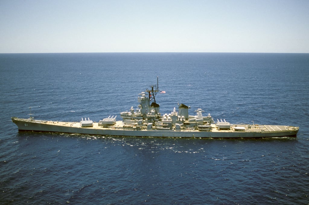 Aerial port beam view of the battleship USS IOWA (BB 61) operating off ...