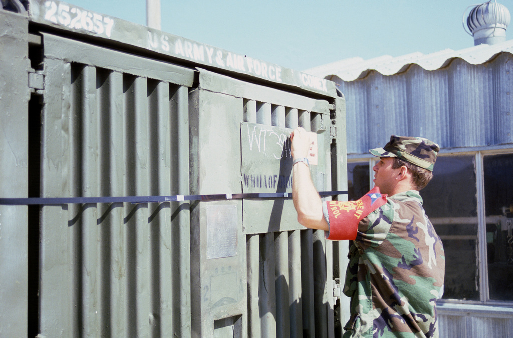 First Lieutenant Michael Barrett marks the weight of a CONEX