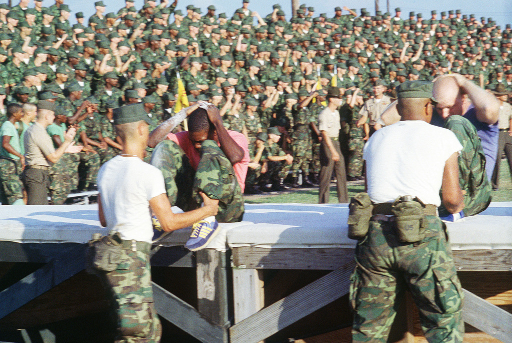 Two Marines perform sit ups during a track and field meet at the