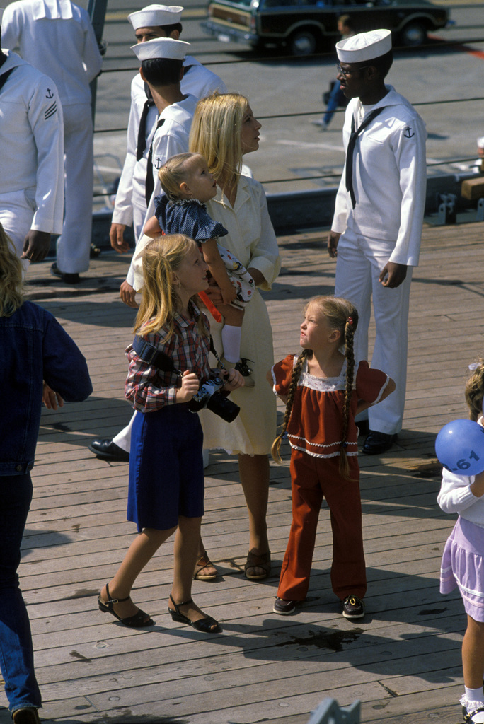 A dependent wife looks for her husband as the battleship USS IOWA (BB ...