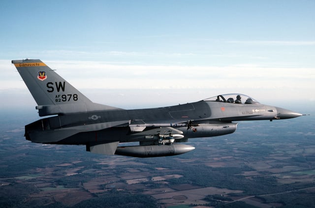 An air-to-air right side view of an F-16 Fighting Falcon aircraft. The ...