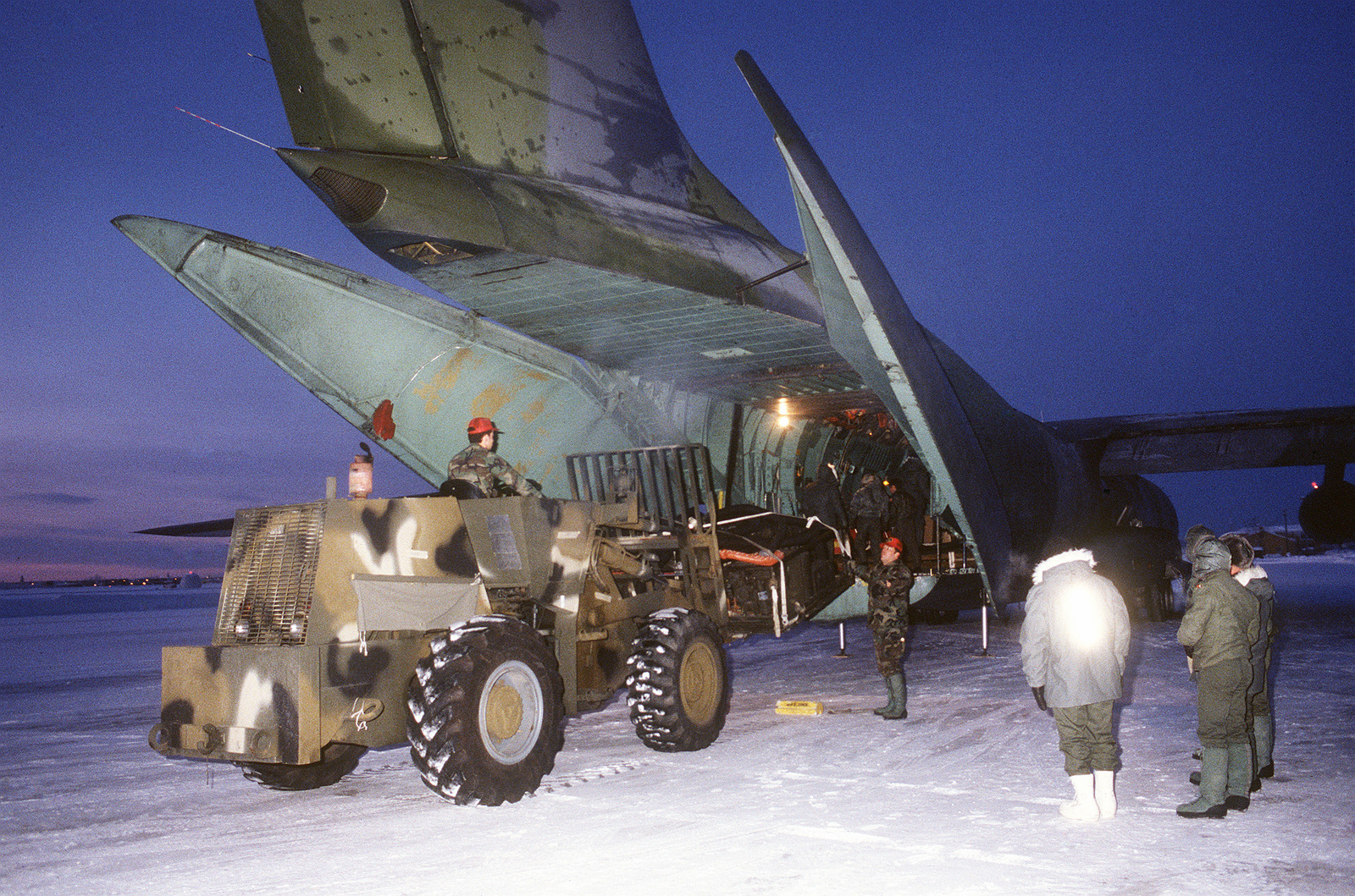 A US Air Force C-141B Starlifter Aircraft Is Unloaded By Members Of The ...