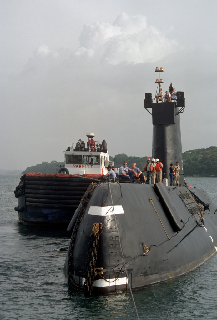 Port bow view of the nuclear-powered attack submarine ex-USS NAUTILUS (SSN  571) being towed through the Gatun Locks. The NAUTILUS is en route to its  original home port at Naval Submarine Base