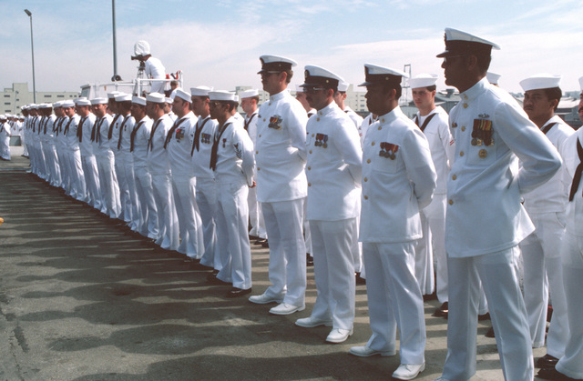 Crewmen of the guided missile frigate USS FORD (FFG 54) stand in ...