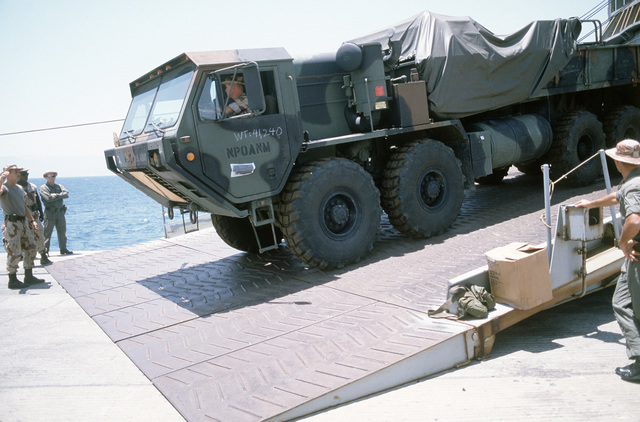 An M-977 Heavy Expanded Mobility Tactical Truck Is Off-loaded From The ...