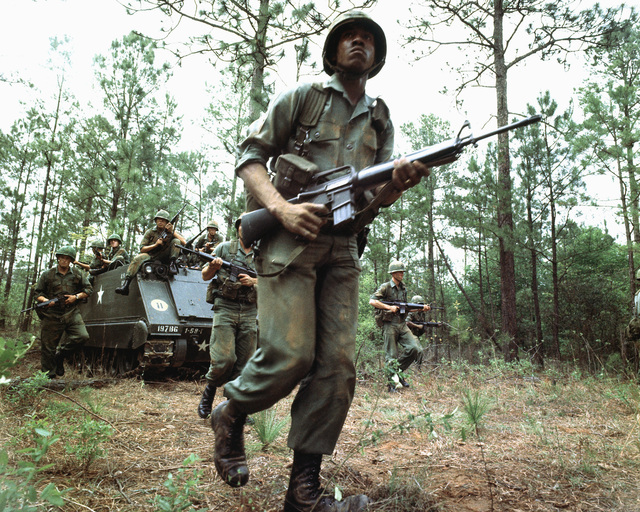 Us Army Infantrymen Armed With M16a1 Rifles Unload From An M113 Armored 