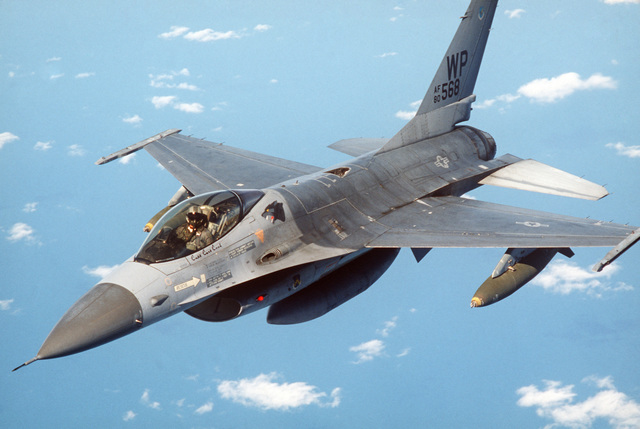 An air-to-air left front view of an 8th Tactical Fighter Wing F-16 ...