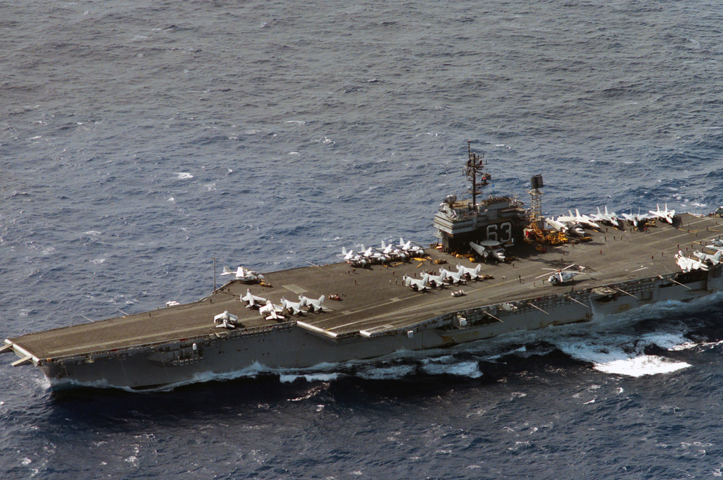 An aerial port bow view of the aircraft carrier USS KITTY HAWK (CV 63 ...