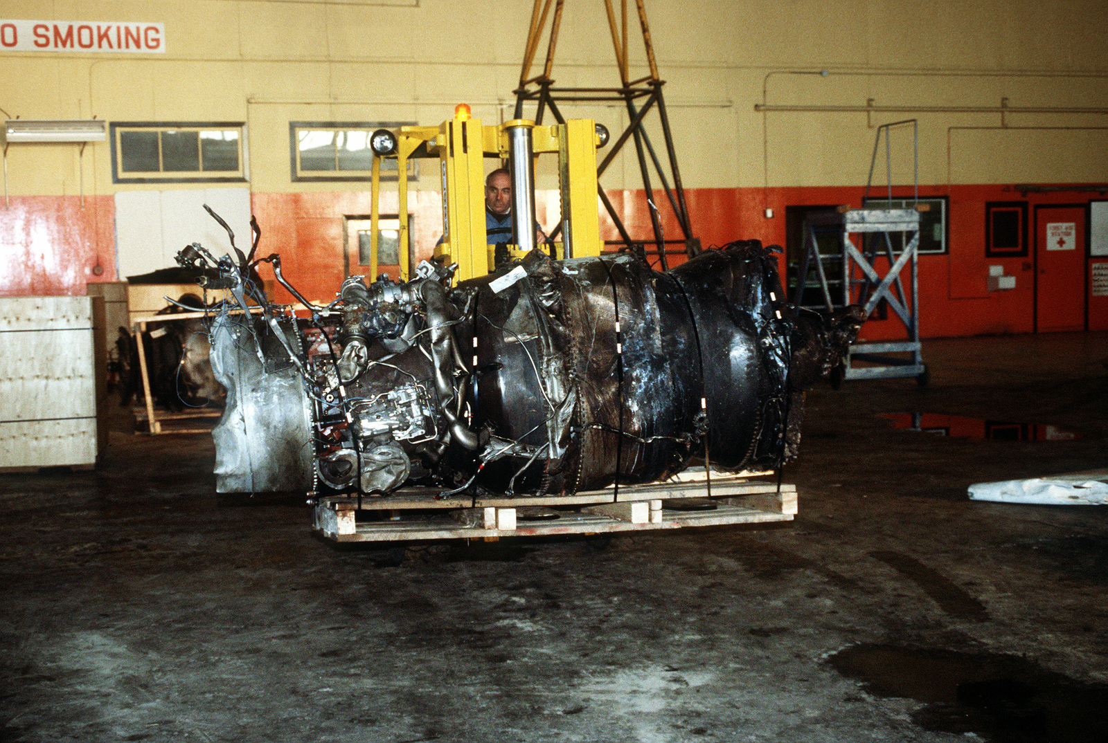 the-demolished-engine-of-an-arrow-air-dc-8-commercial-aircraft-is-stored-in-a-gander-airport