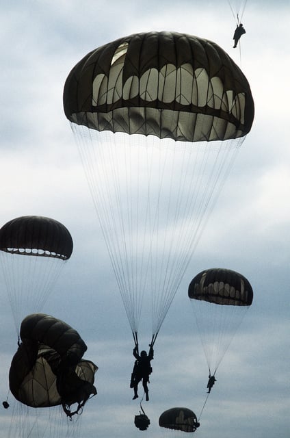 U.S. Army and Korean army paratroopers descend over the Yoju airstrip ...