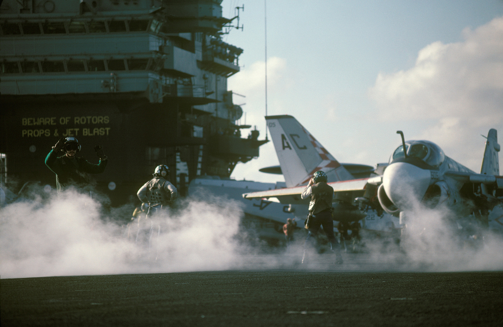 steam-drifts-across-the-flight-deck-as-an-a-6e-intruder-aircraft-is-prepared-for-launch-from-the