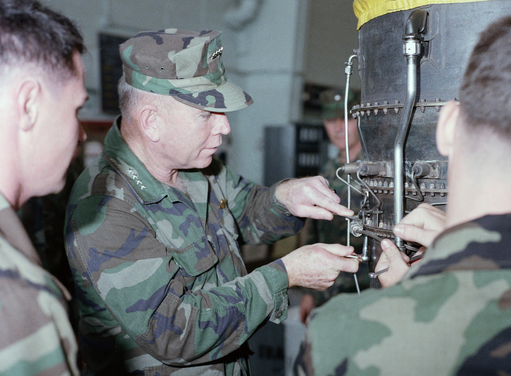 General Gen P X Kelley Commandant Of The Marine Corps Works On A Helicopter Engine In The Maintenance Shop Of Headquarters And Maintenance Squadron 36 H Ms 36 During His Visit To The Base