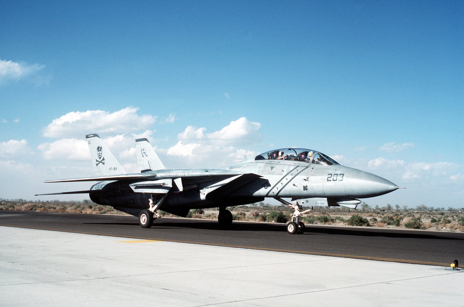 A Fighter Squadron 84 (VF-84) F-14A Tomcat aircraft taxis on the runway ...