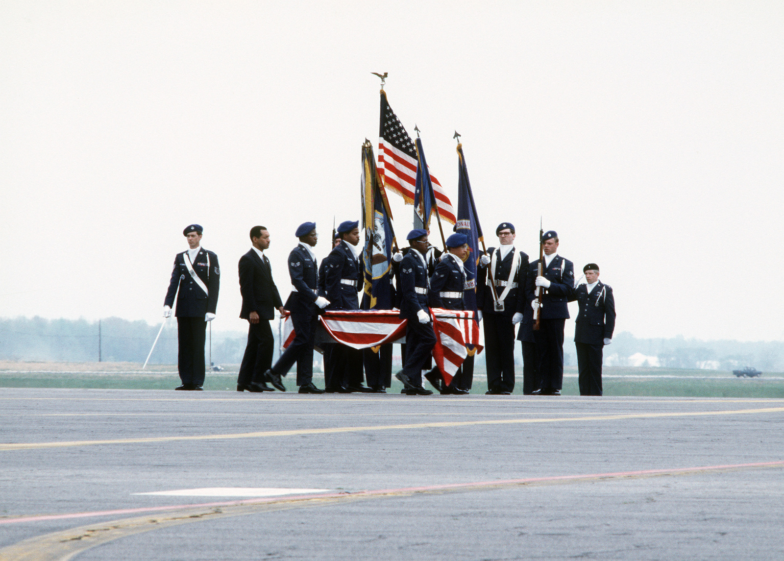 Air Force pallbearers carry a coffin containing the remains of a crew member from the ...