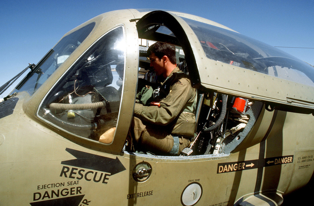 A U.S. Army Pilot And Copilot Secure Themselves In The Cockpit Of An OV ...