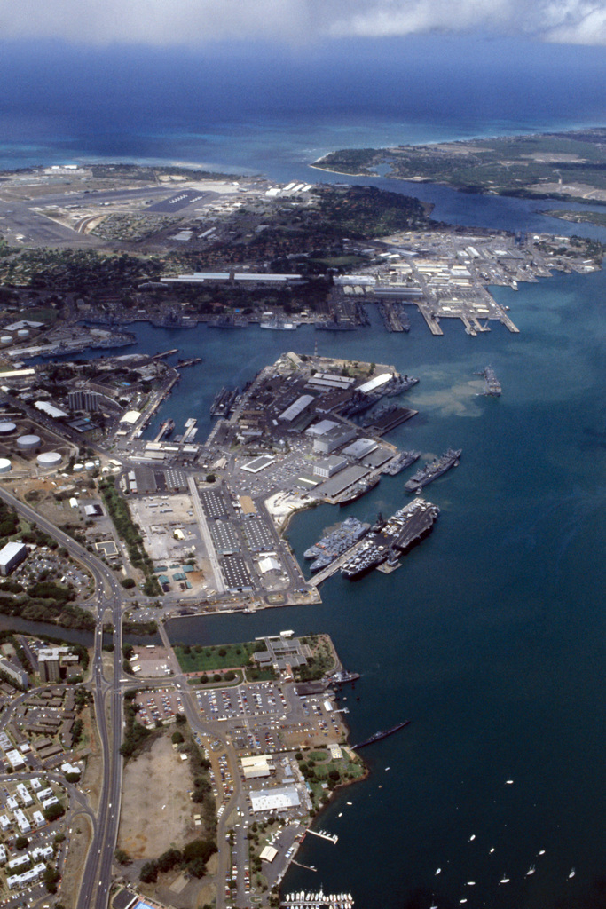 An aerial view of the Naval Shipyard and various ships moored to piers ...