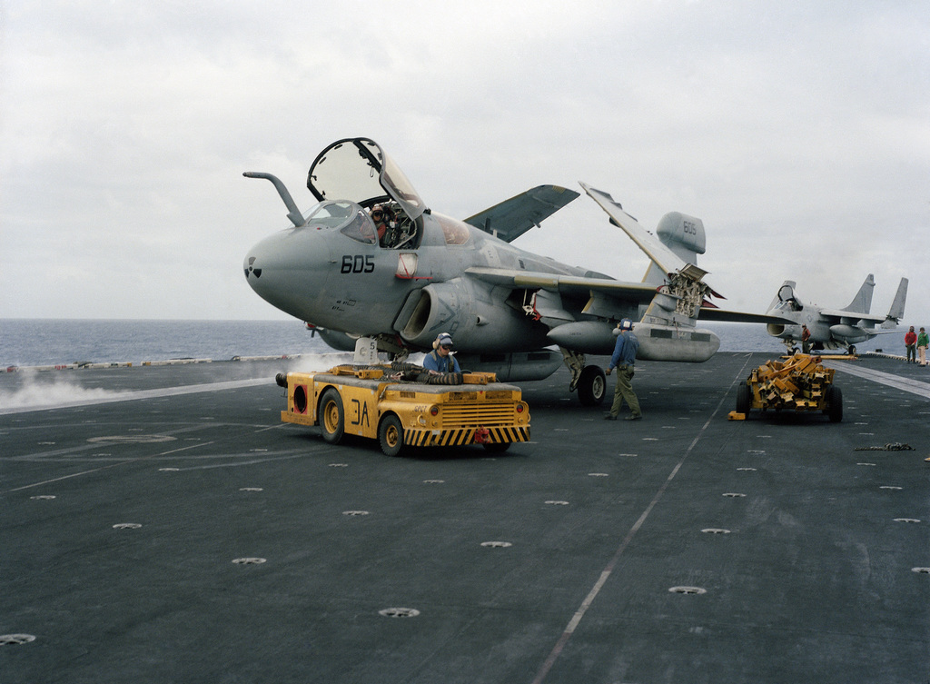 An MD-3 tow tractor is used to tow an EA-6B Intruder aircraft