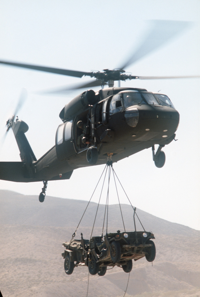 An M151A2 light vehicle and trailer is airlifted by a 101st Airborne ...