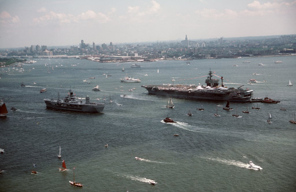 A view of the harbor including US Navy warships and civilian ships ...