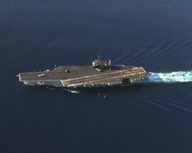 An aerial port beam view the aircraft carrier USS KITTY HAWK (CV 63 ...