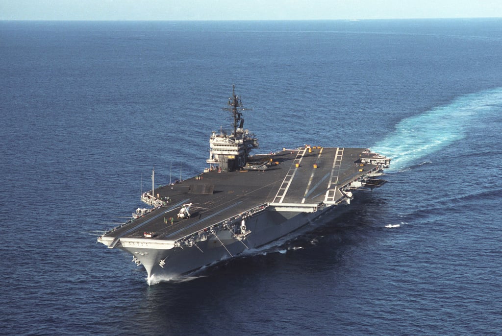 An aerial port bow view of the aircraft carrier USS KITTY HAWK (CV 63 ...