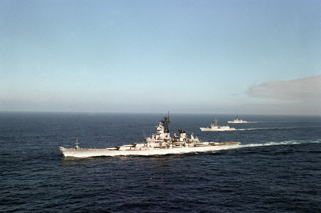 An aerial port bow view of the battleship USS IOWA (BB-61), foreground ...