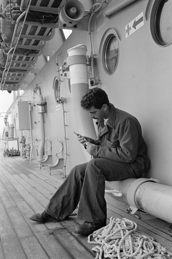 A boatswain's mate works on a piece of line with a marlin spike aboard the battleship USS