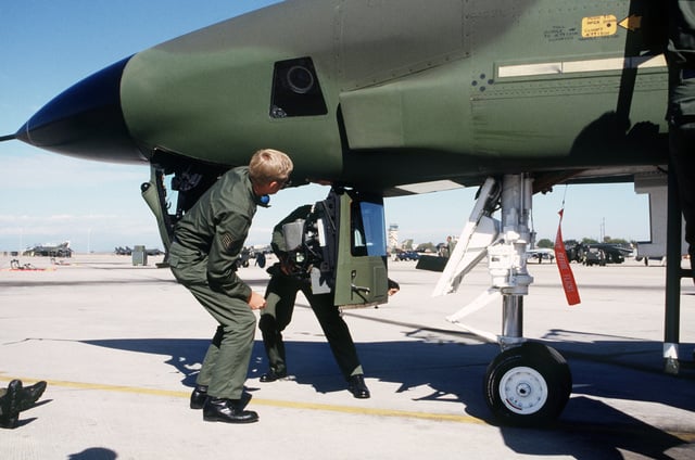 Ground crewmen from Kadena Air Base, Japan, remove the camera assembly ...