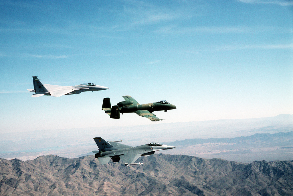 An air-to-air side view of an F-15 Eagle aircraft, an A-10A Thunderbolt ...