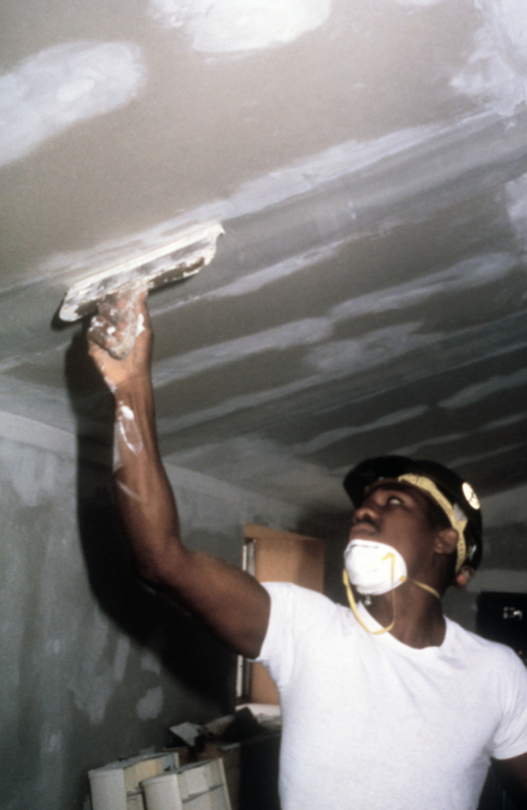 A Member Of Naval Construction Battalion 410 Uses A Trowel To